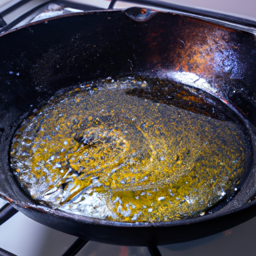 A cast iron skillet being seasoned with vegetable oil.